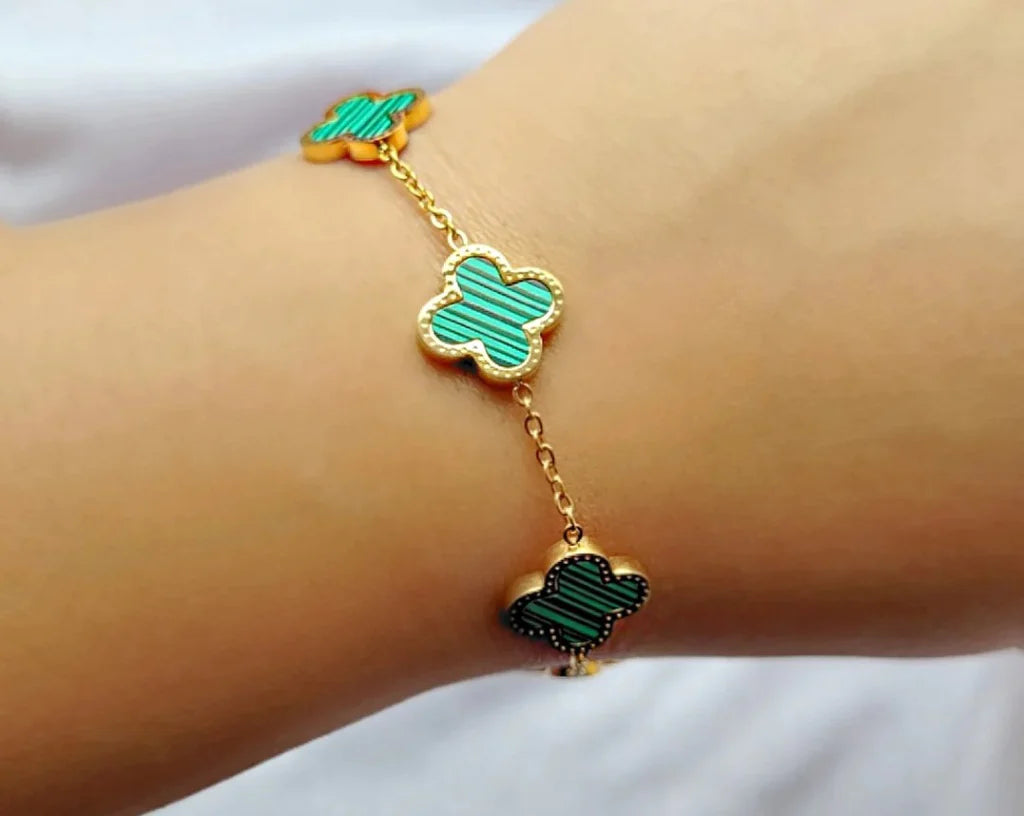 Bracelet featuring charming green clover designs.